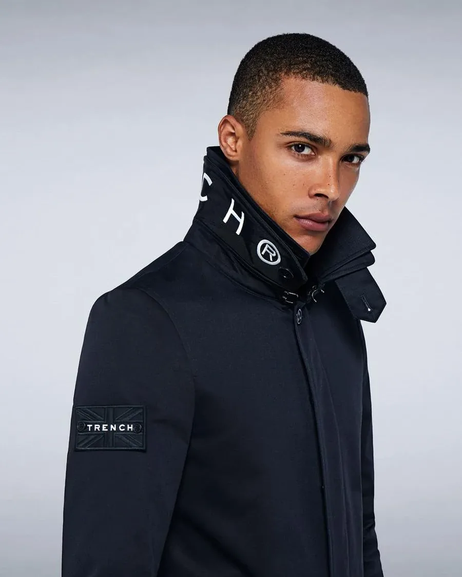 Man wearing a black TRENCH LONDON coat